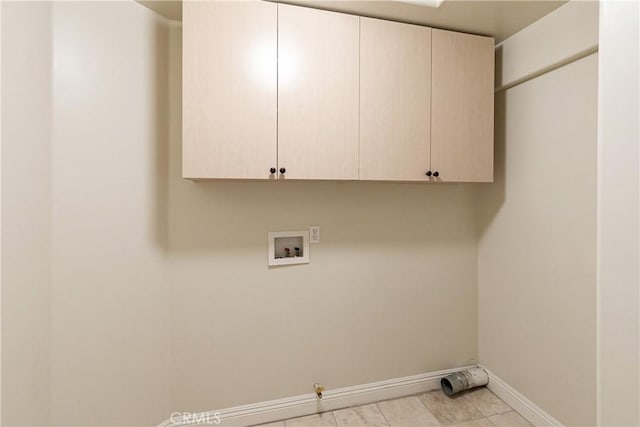 laundry area featuring light tile patterned floors, baseboards, washer hookup, gas dryer hookup, and cabinet space