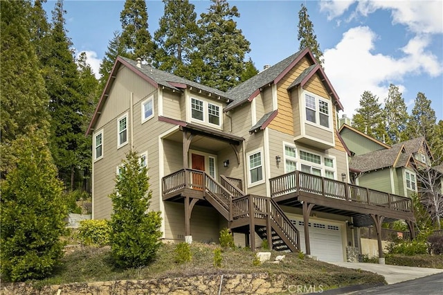 craftsman inspired home with an attached garage, concrete driveway, and stairway