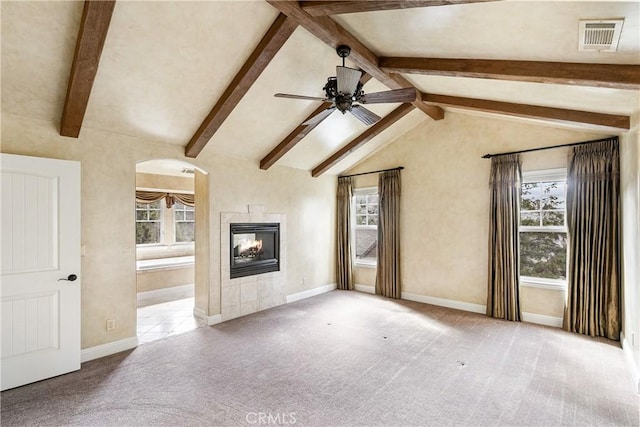 unfurnished living room with a fireplace, a ceiling fan, visible vents, and carpet floors