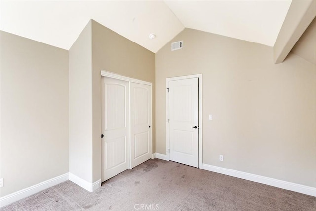 unfurnished bedroom featuring light carpet, baseboards, lofted ceiling, and visible vents