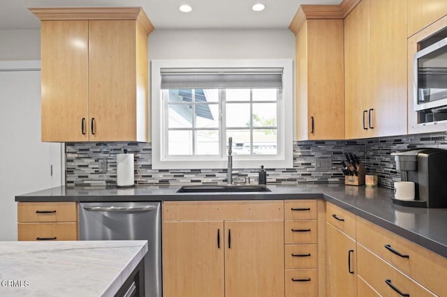kitchen featuring a sink, tasteful backsplash, light brown cabinets, and stainless steel appliances