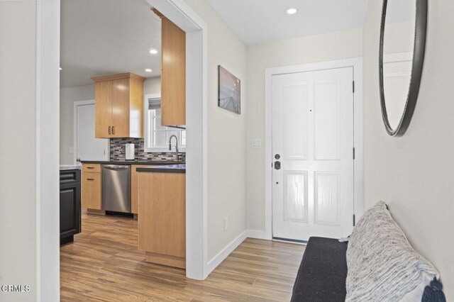 interior space with recessed lighting, light wood-style flooring, and baseboards