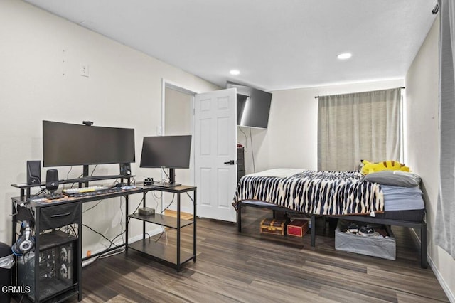 bedroom featuring baseboards, recessed lighting, and wood finished floors