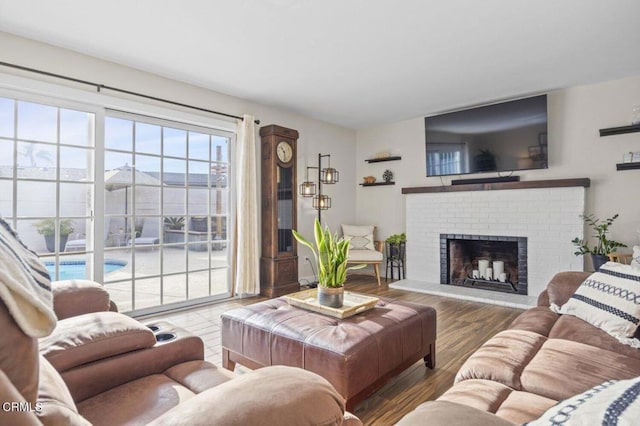 living room with wood finished floors and a fireplace