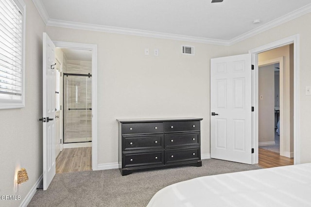 bedroom featuring ensuite bathroom, baseboards, visible vents, crown molding, and carpet floors