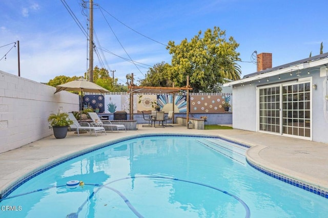 view of pool featuring a patio area, a fenced backyard, and a fenced in pool