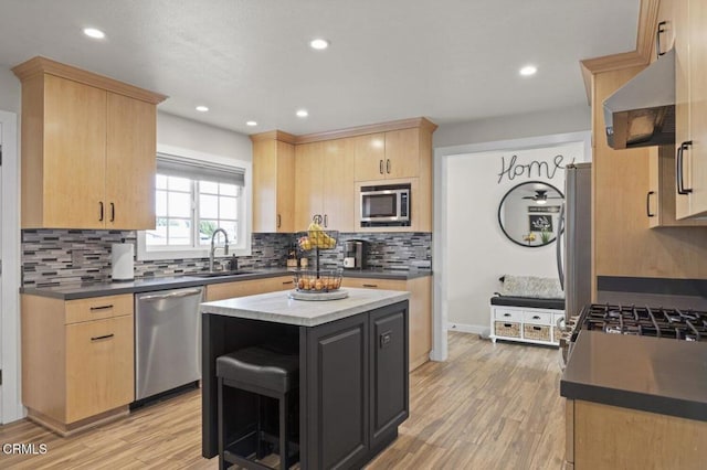 kitchen with extractor fan, appliances with stainless steel finishes, light brown cabinets, and backsplash