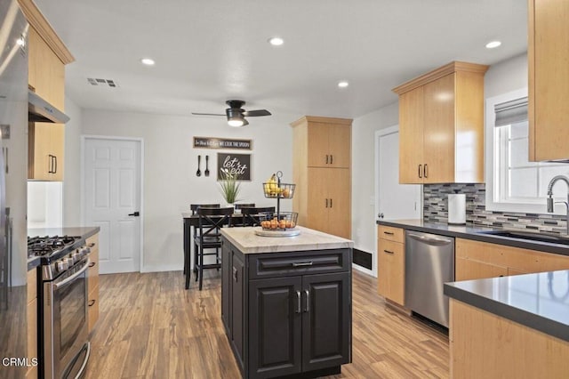kitchen featuring a sink, visible vents, appliances with stainless steel finishes, and light brown cabinets