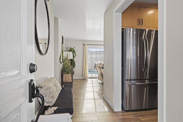 hallway with baseboards and wood finished floors