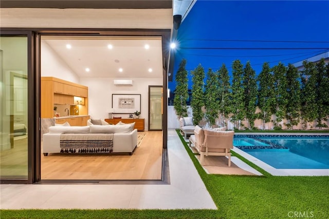 exterior space with a sink, recessed lighting, and a wall mounted AC