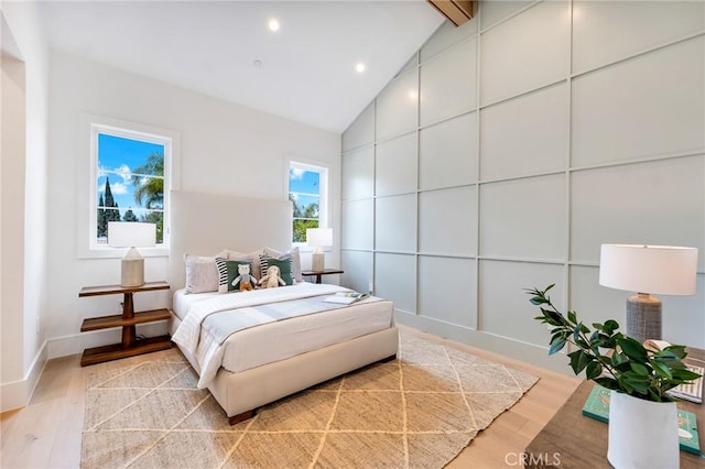 bedroom featuring baseboards, recessed lighting, light wood-style flooring, beam ceiling, and high vaulted ceiling