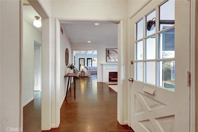 corridor with recessed lighting, baseboards, and dark wood-type flooring