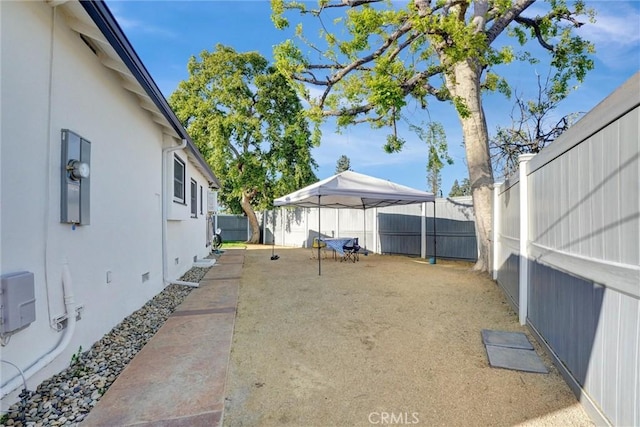 view of yard featuring a gazebo and a fenced backyard