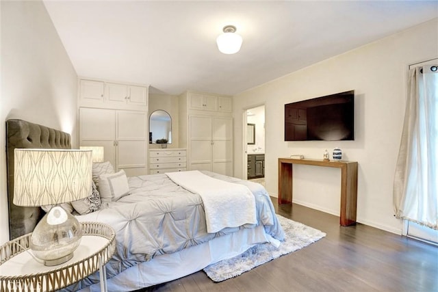 bedroom with wood finished floors and baseboards