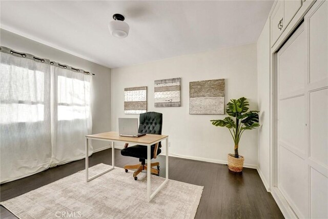 office area featuring dark wood finished floors and baseboards