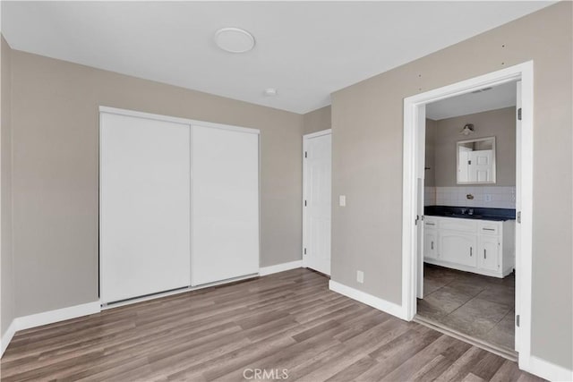 17908 Birch St, Hesperia, CA 92345 - unfurnished bedroom with light wood finished floors, ensuite bathroom, a closet, and baseboards