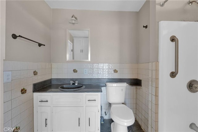 17908 Birch St, Hesperia, CA 92345 - bathroom featuring toilet, vanity, a wainscoted wall, and tile walls