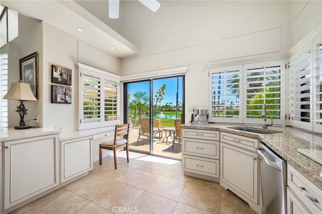 28 Lost River Dr, Palm Desert, CA 92211 - kitchen featuring stainless steel dishwasher, a wealth of natural light, a ceiling fan, and light tile patterned flooring