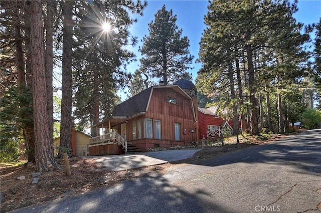 31867 Wagon Wheel Dr, Running Springs, CA 92382 - view of front of property featuring a gambrel roof, driveway, a shingled roof, and a barn