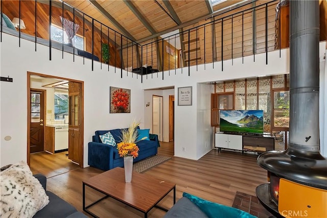 31867 Wagon Wheel Dr, Running Springs, CA 92382 - living area featuring wooden ceiling with exposed beams, wood finished floors, healthy amount of natural light, and high vaulted ceiling