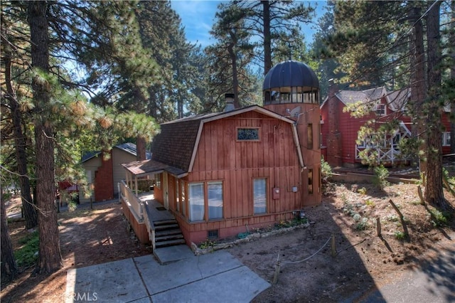 31867 Wagon Wheel Dr, Running Springs, CA 92382 - back of property with a gambrel roof, a shingled roof, and a deck