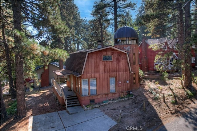 31867 Wagon Wheel Dr, Running Springs, CA 92382 - view of front of property featuring a gambrel roof, roof with shingles, and a wooden deck