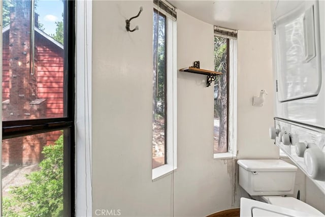 31867 Wagon Wheel Dr, Running Springs, CA 92382 - bathroom featuring stacked washer and clothes dryer and toilet