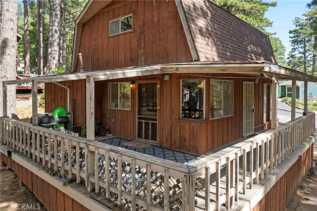 31867 Wagon Wheel Dr, Running Springs, CA 92382 - view of home's exterior with a gambrel roof and roof with shingles
