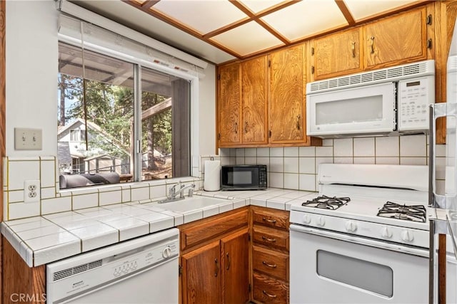 31867 Wagon Wheel Dr, Running Springs, CA 92382 - kitchen featuring white appliances, tasteful backsplash, and brown cabinetry