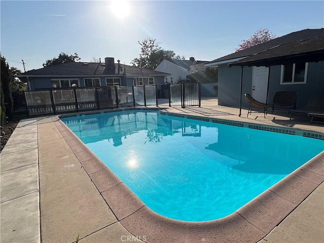 view of swimming pool with a patio, a fenced in pool, and fence