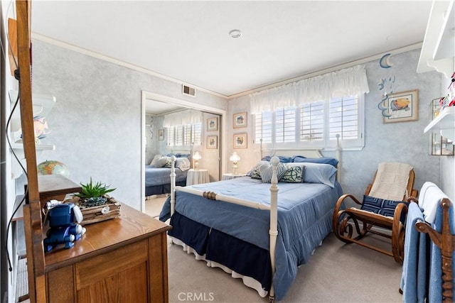 bedroom featuring a closet, visible vents, light colored carpet, and crown molding