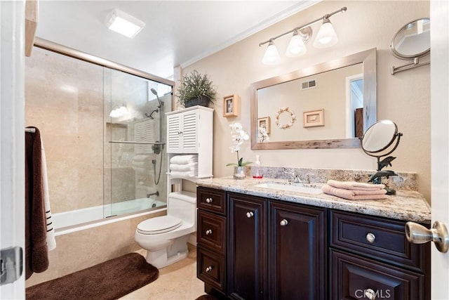 full bathroom featuring crown molding, shower / bath combination with glass door, vanity, visible vents, and toilet