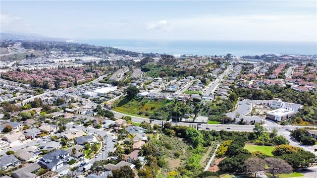 drone / aerial view with a water view and a residential view