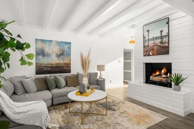 22495 Sierra Dr, Palm Springs, CA 92262 - living room with wood finished floors, a lit fireplace, beamed ceiling, and baseboards