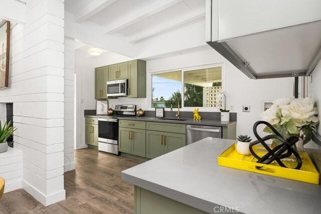 22495 Sierra Dr, Palm Springs, CA 92262 - kitchen featuring a sink, dark wood-style flooring, beam ceiling, stainless steel appliances, and green cabinetry