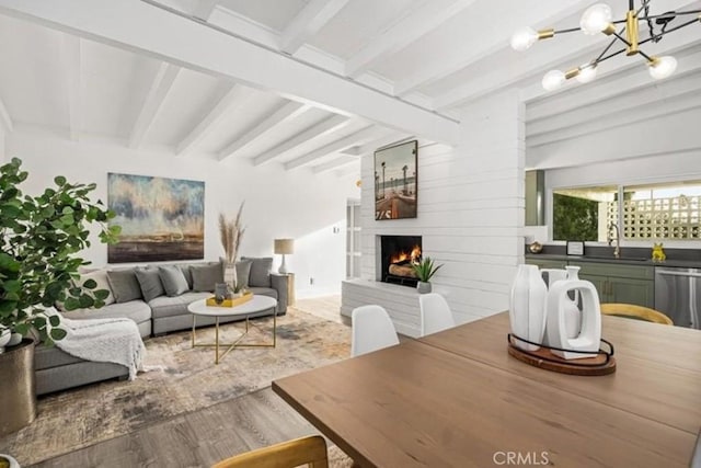 22495 Sierra Dr, Palm Springs, CA 92262 - living area featuring beamed ceiling, an inviting chandelier, wood finished floors, and a fireplace