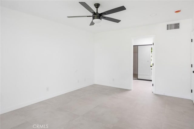 spare room with a ceiling fan, baseboards, and visible vents