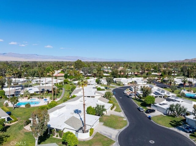 1910 Grand Bahama Dr E, Palm Springs, CA 92264 - aerial perspective of suburban area featuring a mountain backdrop and a pool