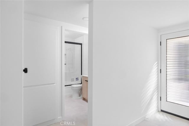 corridor featuring baseboards