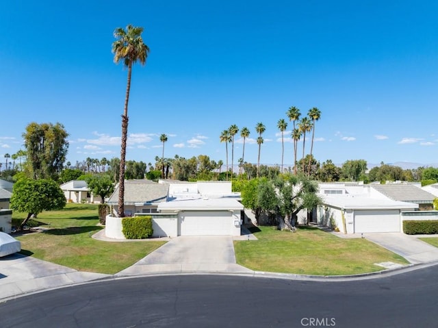 view of front of property featuring a garage, a front lawn, and driveway