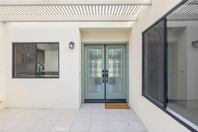1910 Grand Bahama Dr E, Palm Springs, CA 92264 - property entrance featuring french doors and stucco siding