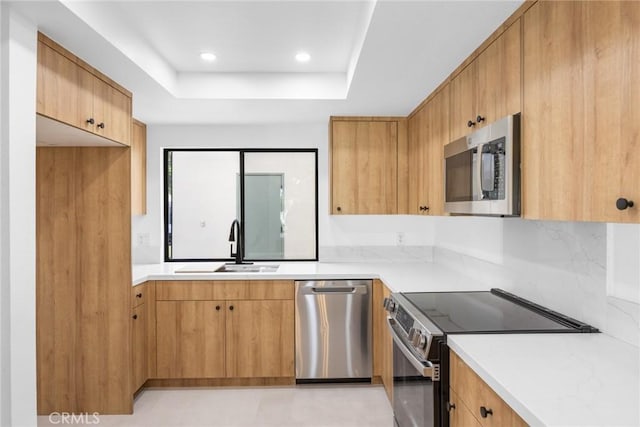 1910 Grand Bahama Dr E, Palm Springs, CA 92264 - kitchen featuring stainless steel appliances, a sink, light countertops, a raised ceiling, and recessed lighting