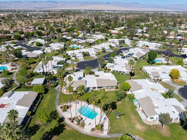 1910 Grand Bahama Dr E, Palm Springs, CA 92264 - aerial view of property and surrounding area with a pool area, nearby suburban area, and mountains