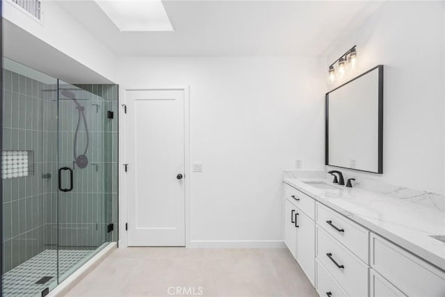 full bath with vanity, baseboards, visible vents, and a shower stall