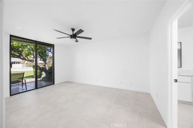 1910 Grand Bahama Dr E, Palm Springs, CA 92264 - empty room with a wall of windows and a ceiling fan