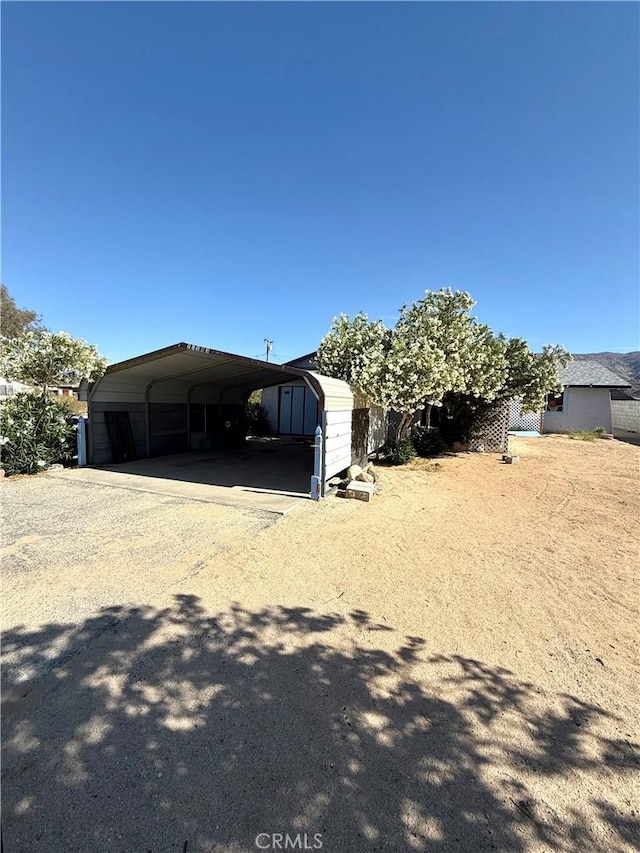 72183 Sunnyvale Dr Unit 29, Palms, CA 92277 - view of front of property with dirt driveway and a carport