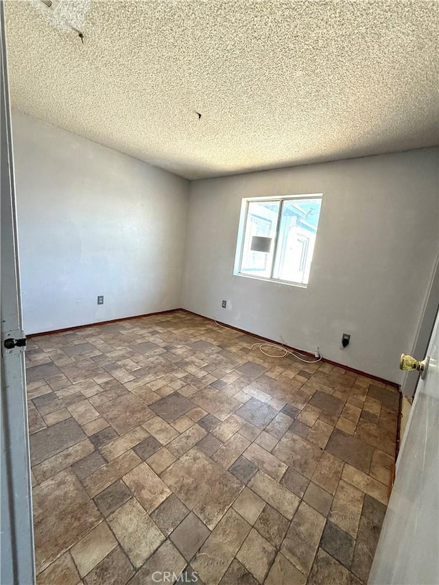 72183 Sunnyvale Dr Unit 29, Palms, CA 92277 - spare room featuring baseboards and a textured ceiling