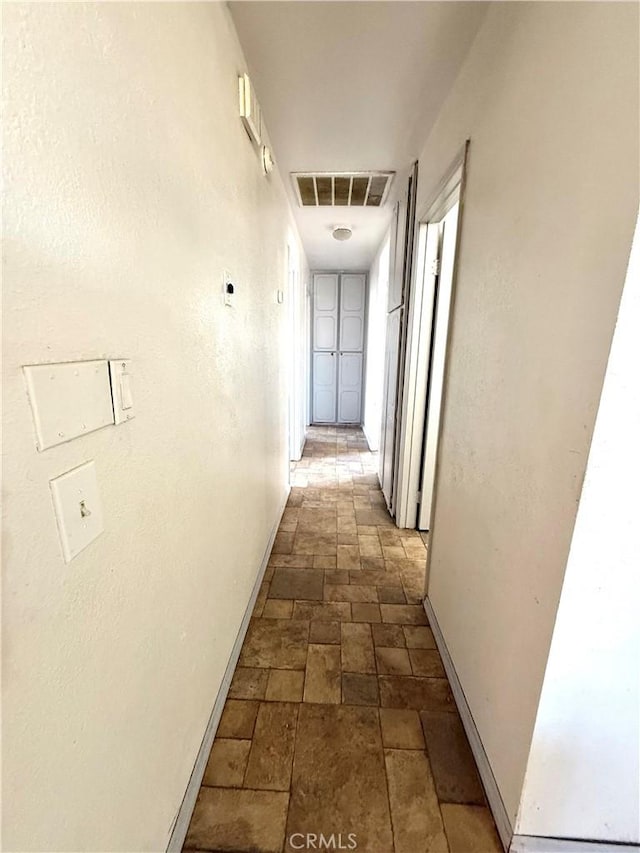 72183 Sunnyvale Dr Unit 29, Palms, CA 92277 - hall featuring dark stone finish flooring and baseboards