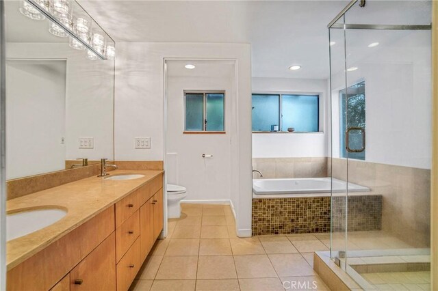 5084 Llano Dr, Woodland Hills, CA 91364 - bathroom featuring a stall shower, tile patterned floors, toilet, double vanity, and a garden tub