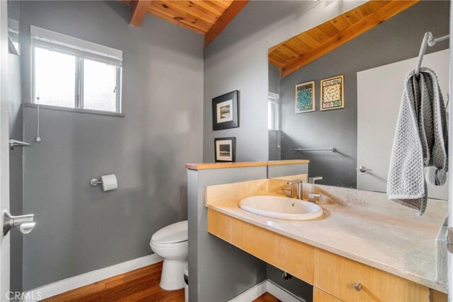 5084 Llano Dr, Woodland Hills, CA 91364 - half bath featuring wooden ceiling, toilet, wood finished floors, baseboards, and vanity